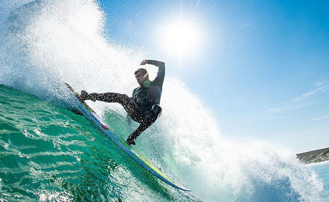 Surfer checking the fit of a wetsuit