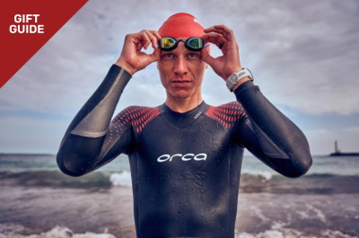 Triathlete in a swim wetsuit swimming in open water
